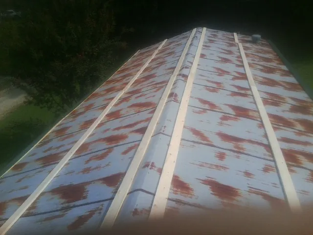 Rusted metal roof panels with new wood purlins before replacement — Storm Damage Roof Repair in Ranger by Roofing Brothers